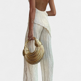 Elegante conjunto plisado con top halter asimétrico y pantalón fluido para un estilo sofisticado
