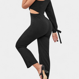 Elegante vestido mono asimétrico Sahar con corte en el bícleo, manga larga y detalle anudado